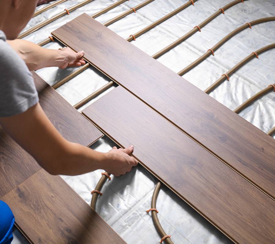 Parkettverlegung auf Fußbodenheizung mit sichtbaren Heizrohren